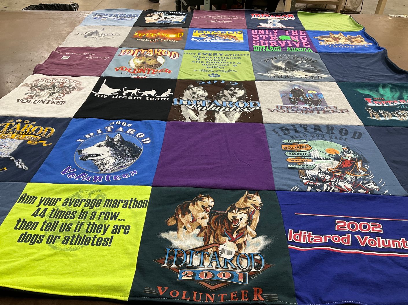 T-shirt quilt with dog sledding, volunteering themes by Jennifer from AK