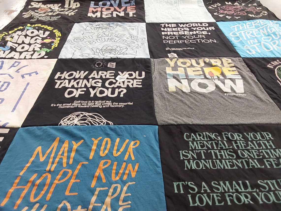 T-shirt quilt with mental health, self care themes by Lisa from FL