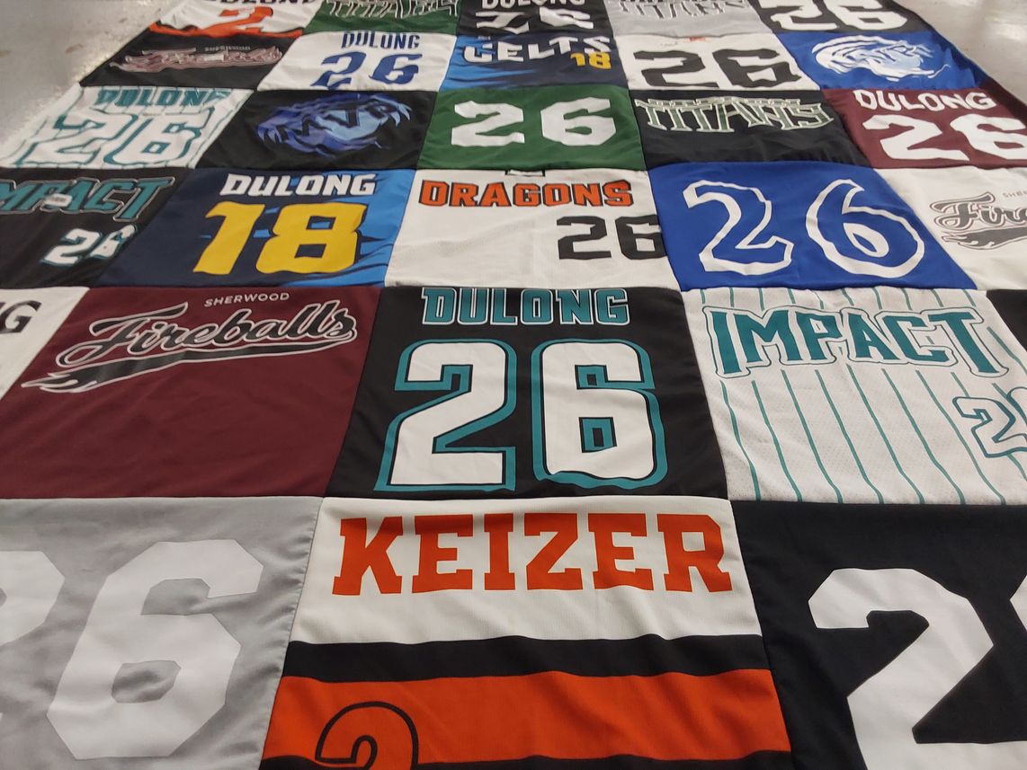 T-shirt quilt with sports themes by Megan from OR