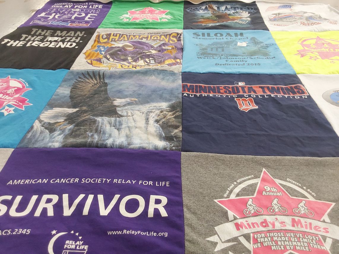 T-shirt quilt with cancer awareness, community events themes by Darcy from MN