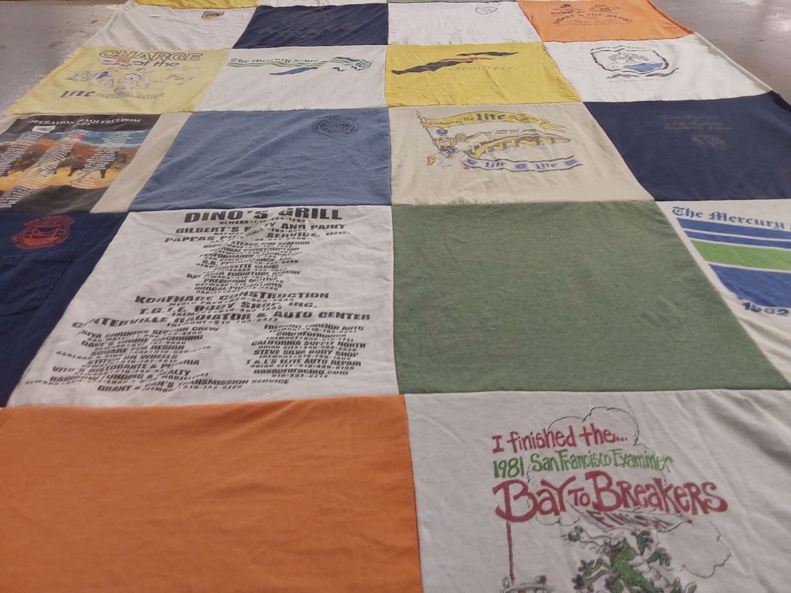 T-shirt quilt with running, local news themes by Alicia from CA