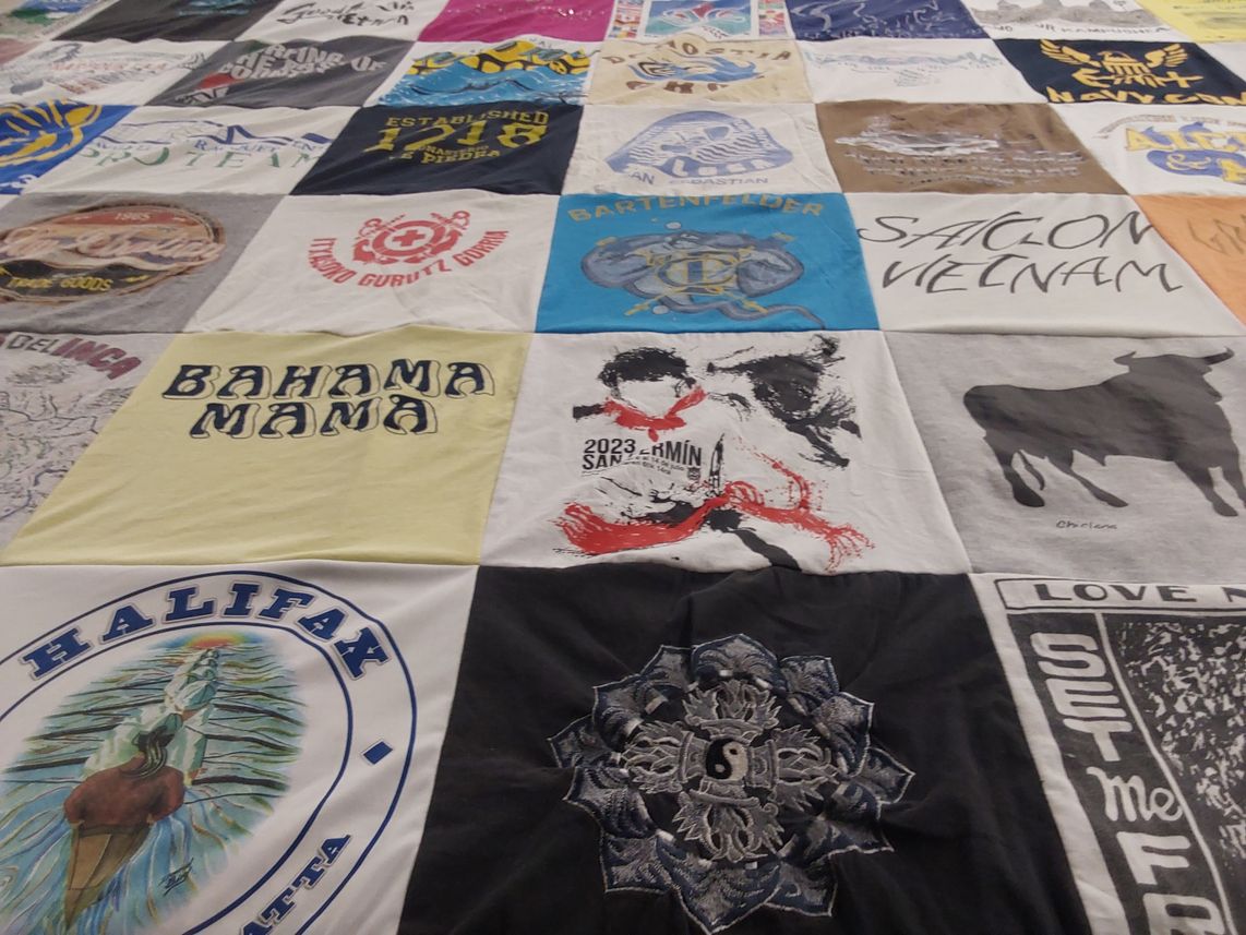 T-shirt quilt with travel, bartending themes by Laura from FL