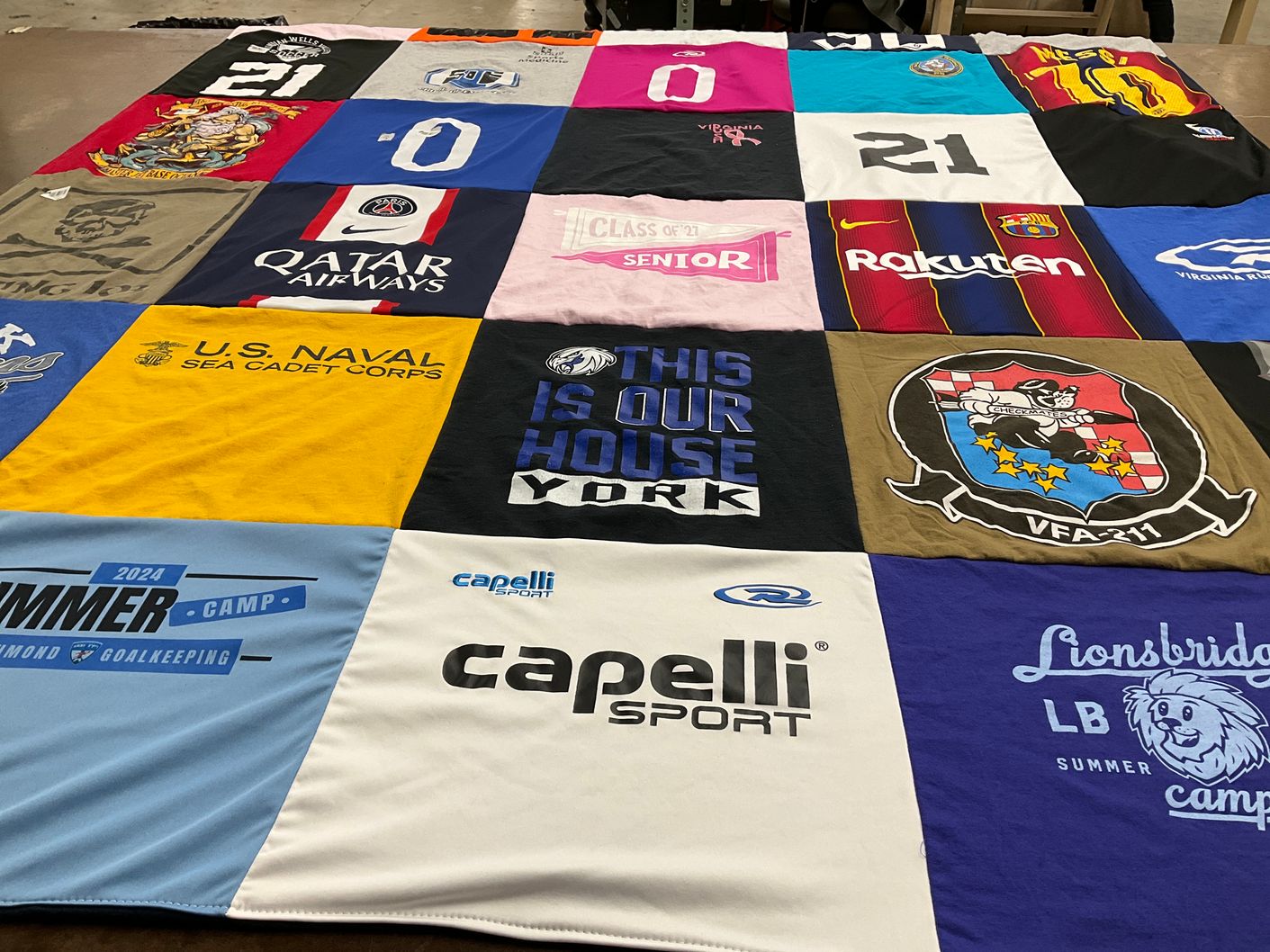 T-shirt quilt with sports, education themes by Nancy from VA