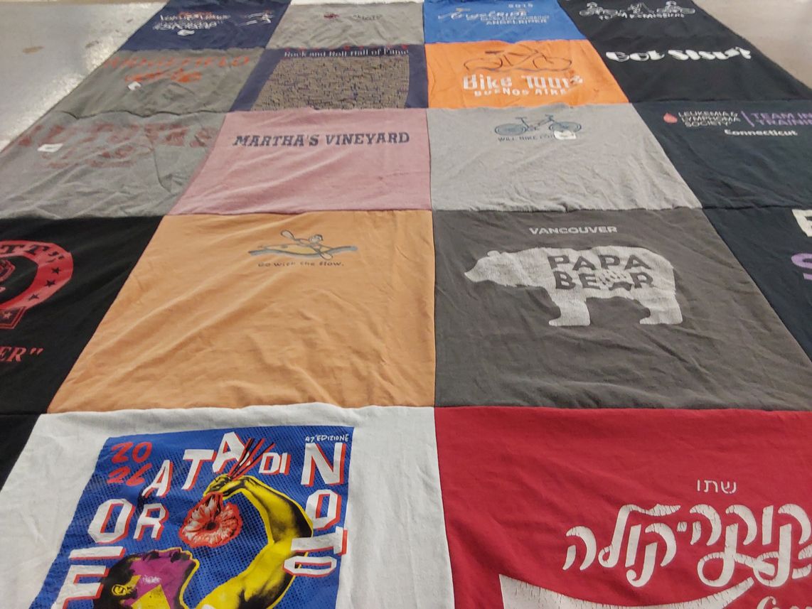 T-shirt quilt with cycling, travel themes by Donald P. from CT