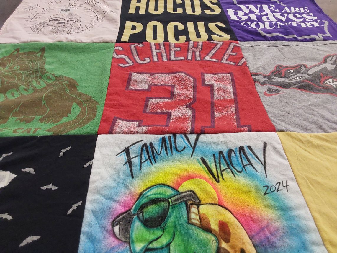 T-shirt quilt with family vacations themes by Laura from GA