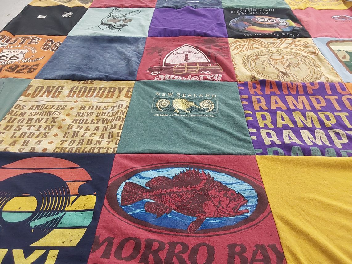 T-shirt quilt with travel, music themes by Kim from CA