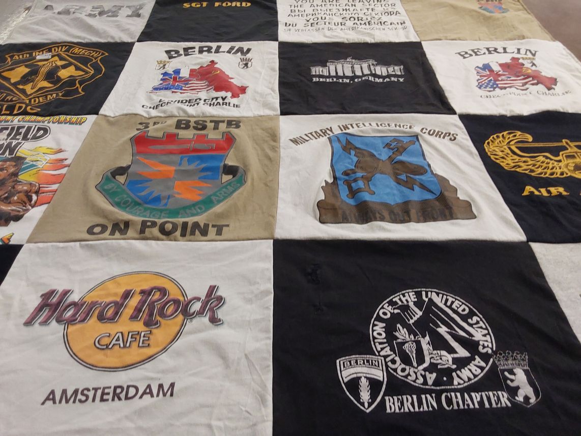 T-shirt quilt with military, travel themes by Joan from KY