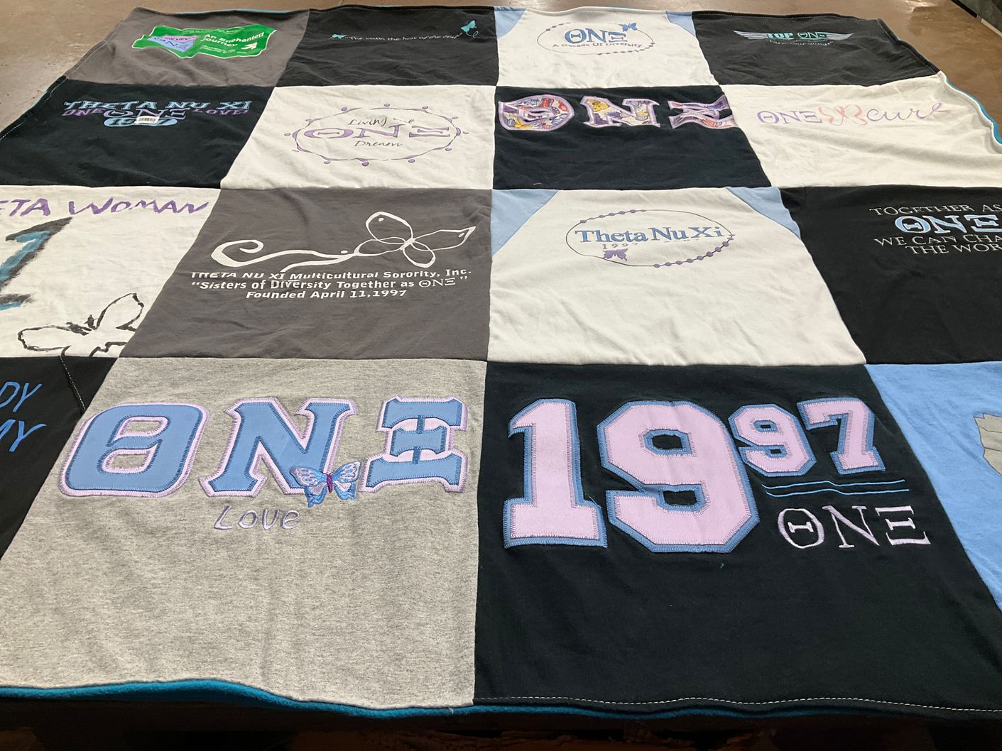 T-shirt quilt with sisterhood, diversity themes by Kitsey from NC