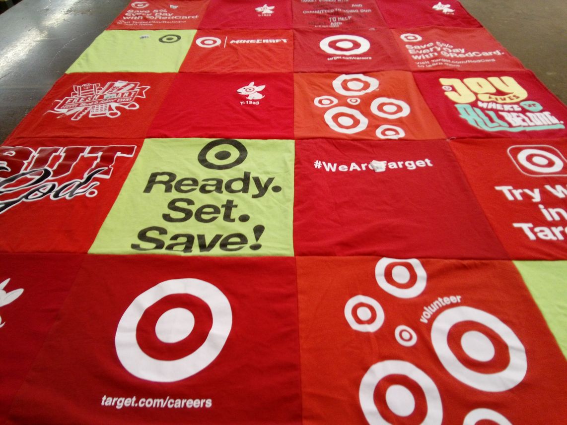 T-shirt quilt with shopping, community service themes by Nadine from MD