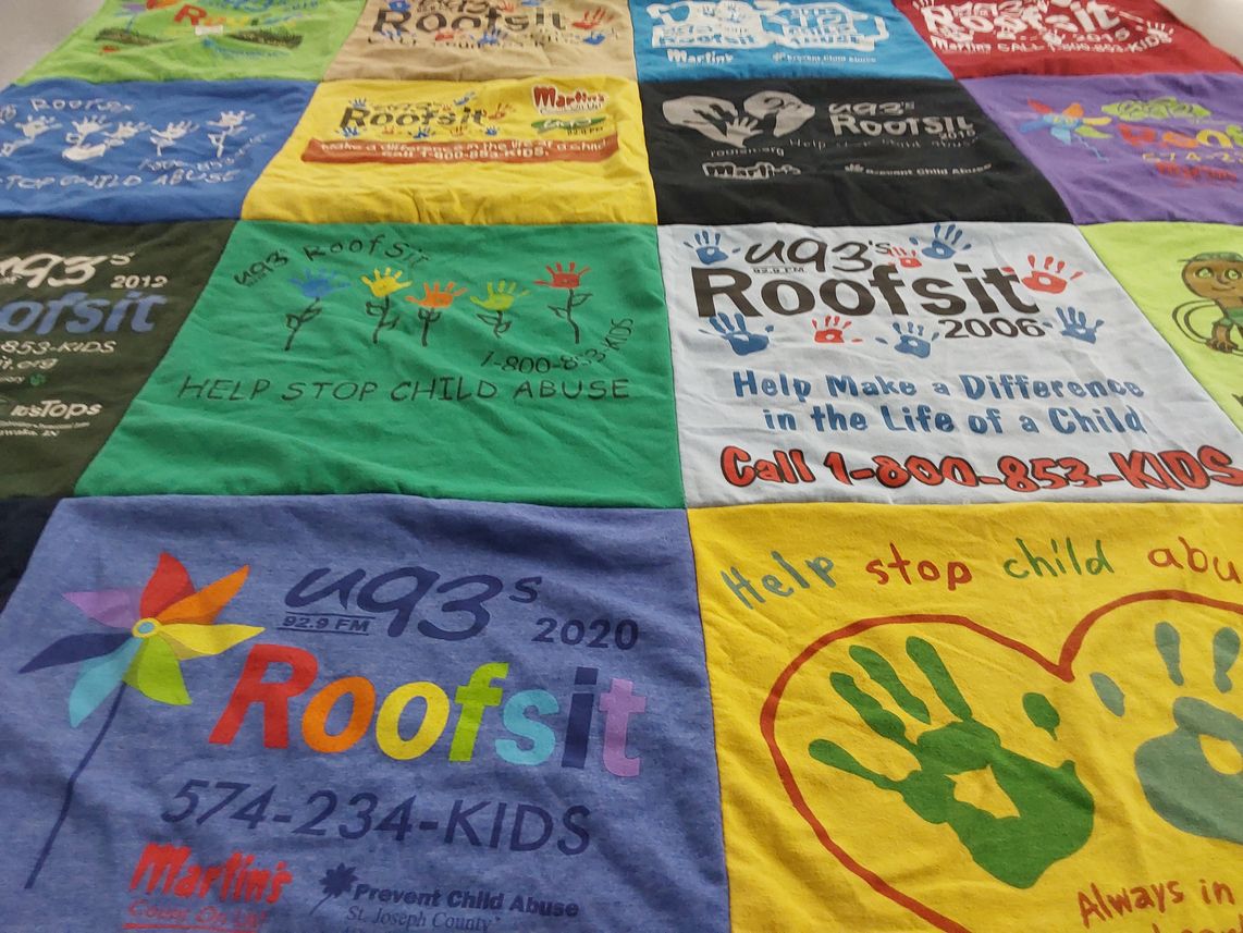 T-shirt quilt with child advocacy, community support themes by Carrie from IN