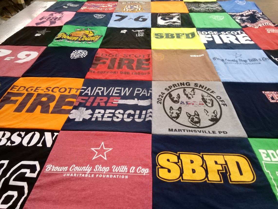 T-shirt quilt with firefighting, community service themes by Laura from IN