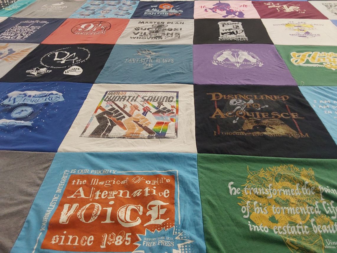 T-shirt quilt with journalism, wizardry themes by Mary from FL