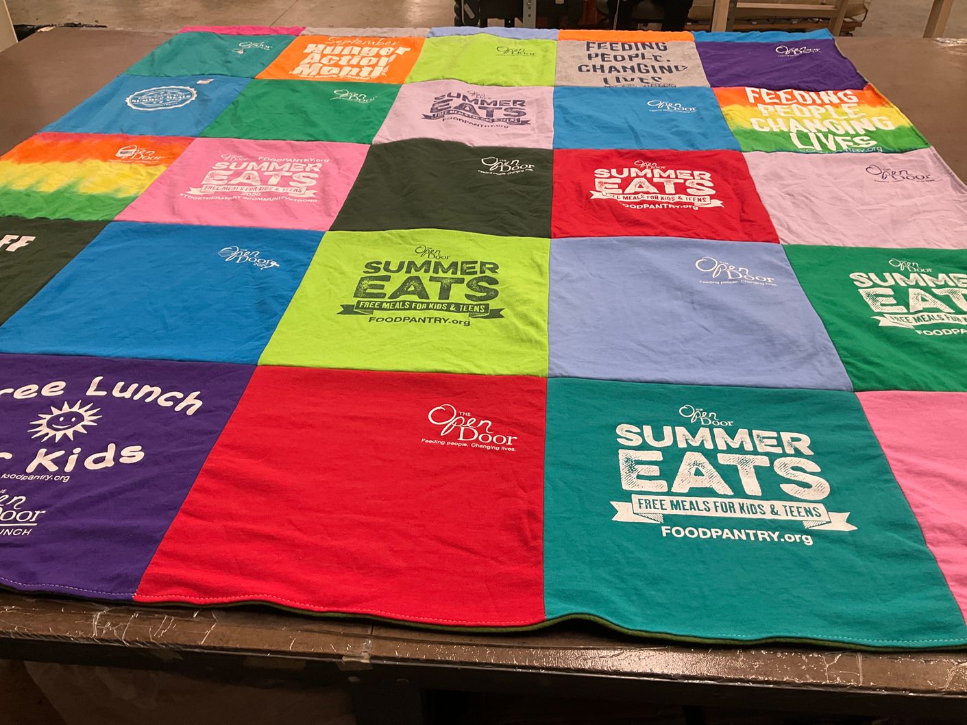 T-shirt quilt with food assistance, community service themes by Sarah from MA