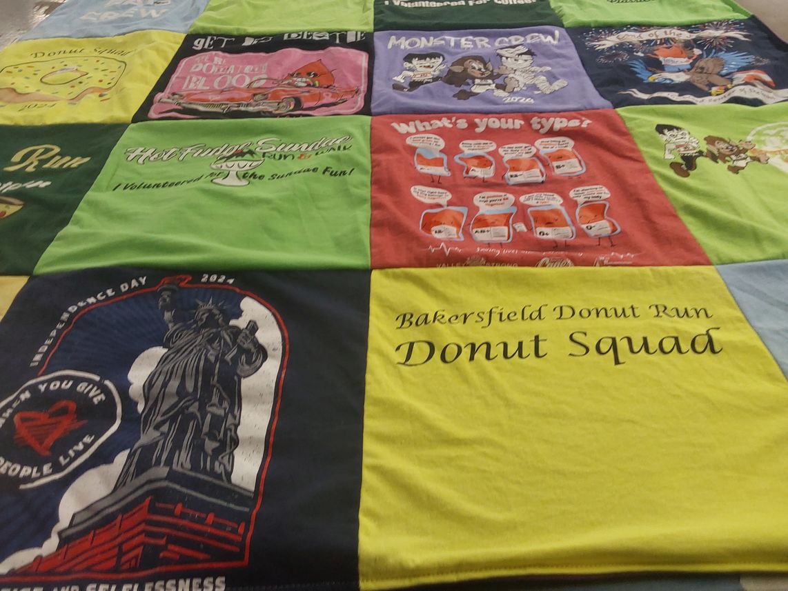 T-shirt quilt with volunteering, food themes by Dell from CA