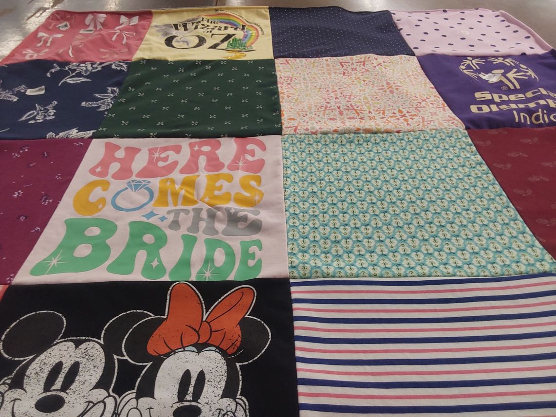 T-shirt quilt with weddings, sports themes by Delores from IN